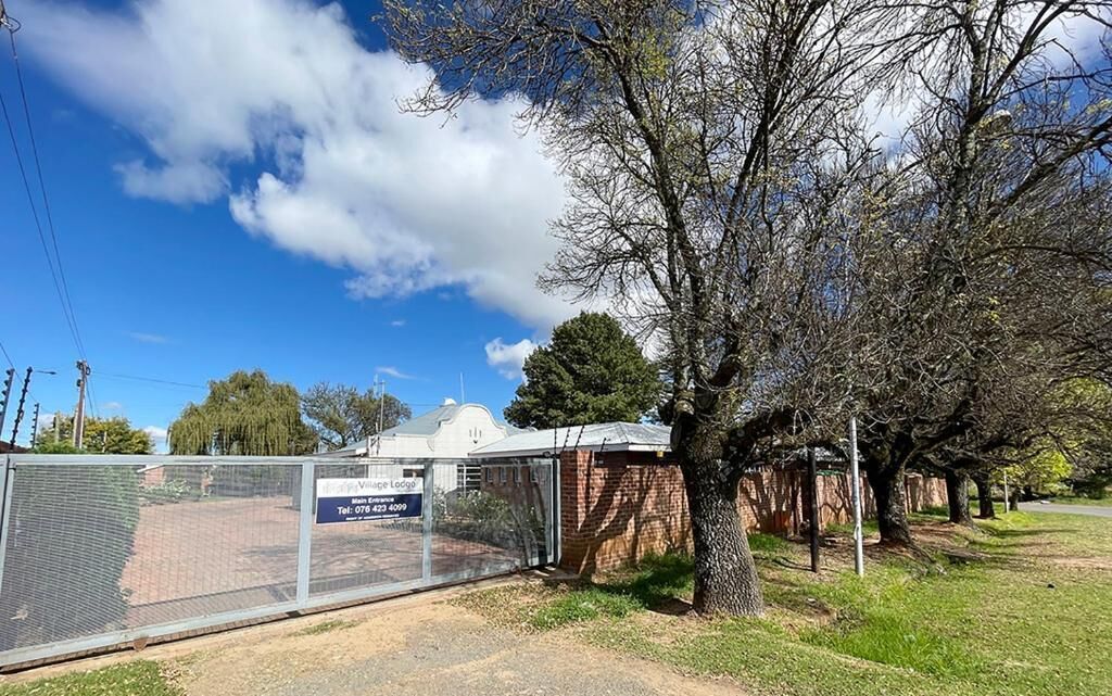 A fenced property with a sign indicating a vacant lot.