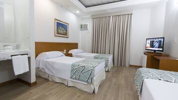 Standard Triple Room | Minibar, in-room safe, desk, blackout drapes
