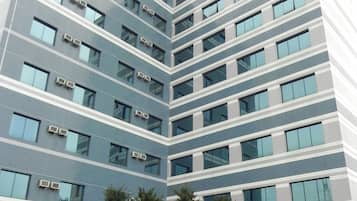 Stylish hotel building with ample natural light and parking facilities.
