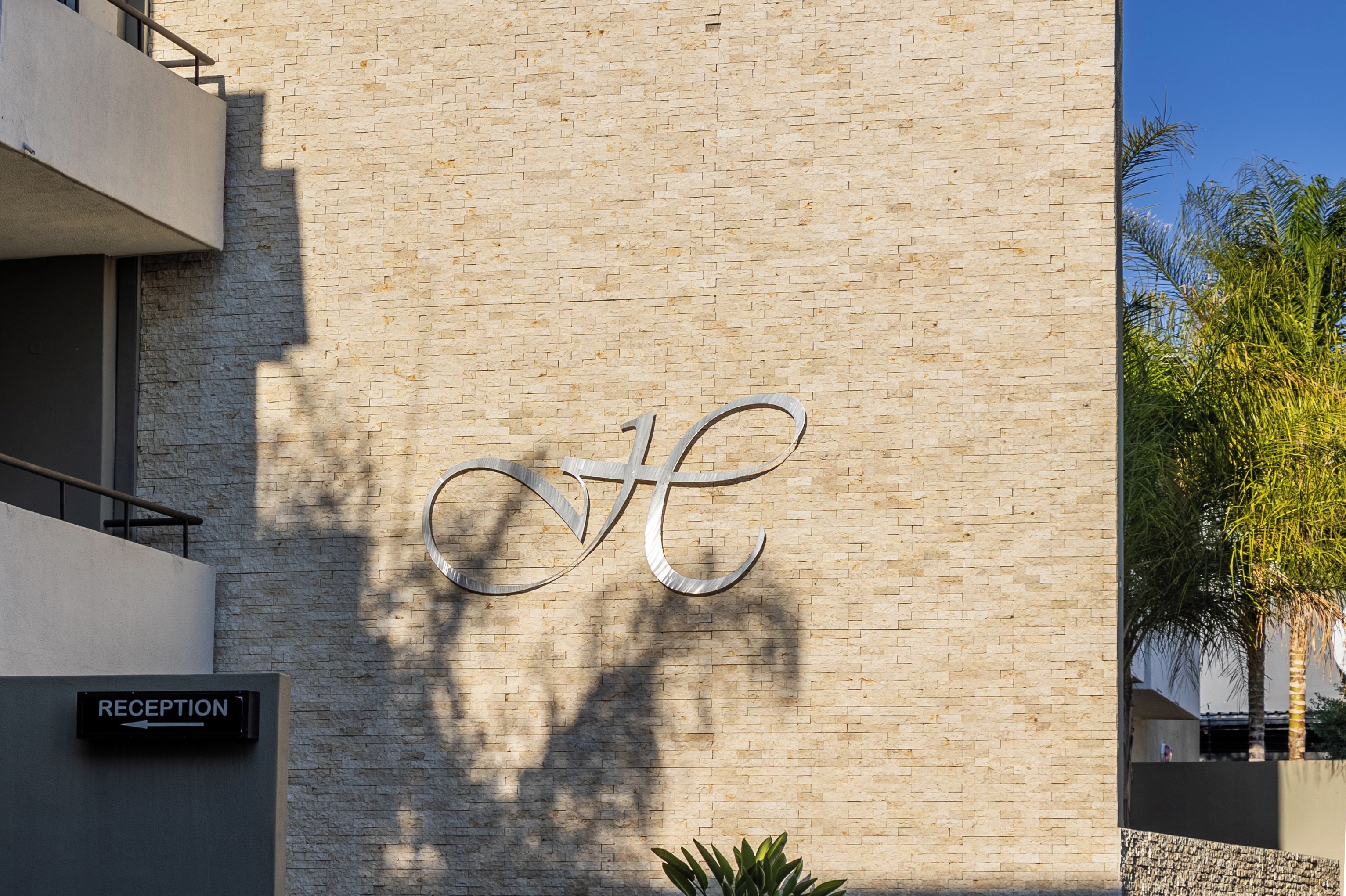 A reception sign on a building with a bicycle symbol on the wall.