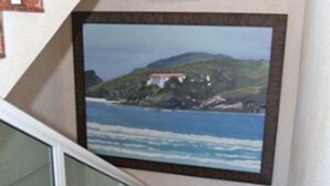 A staircase with a glass railing leading to a landing. - Pousada Águas do Forte (Cabo Frio)