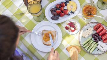 A table with breakfast items including toast, fruits, and beverages.