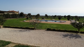 A residential property with a swimming pool, a lawn, and a gravel driveway. - Agriturismo Podere 1248 (Ladispoli)