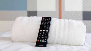 A remote control on a white pillow. - easyHotel Glasgow (Glasgow)