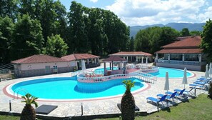 Seasonal outdoor pool, open 10:00 AM to 7:00 PM, pool umbrellas