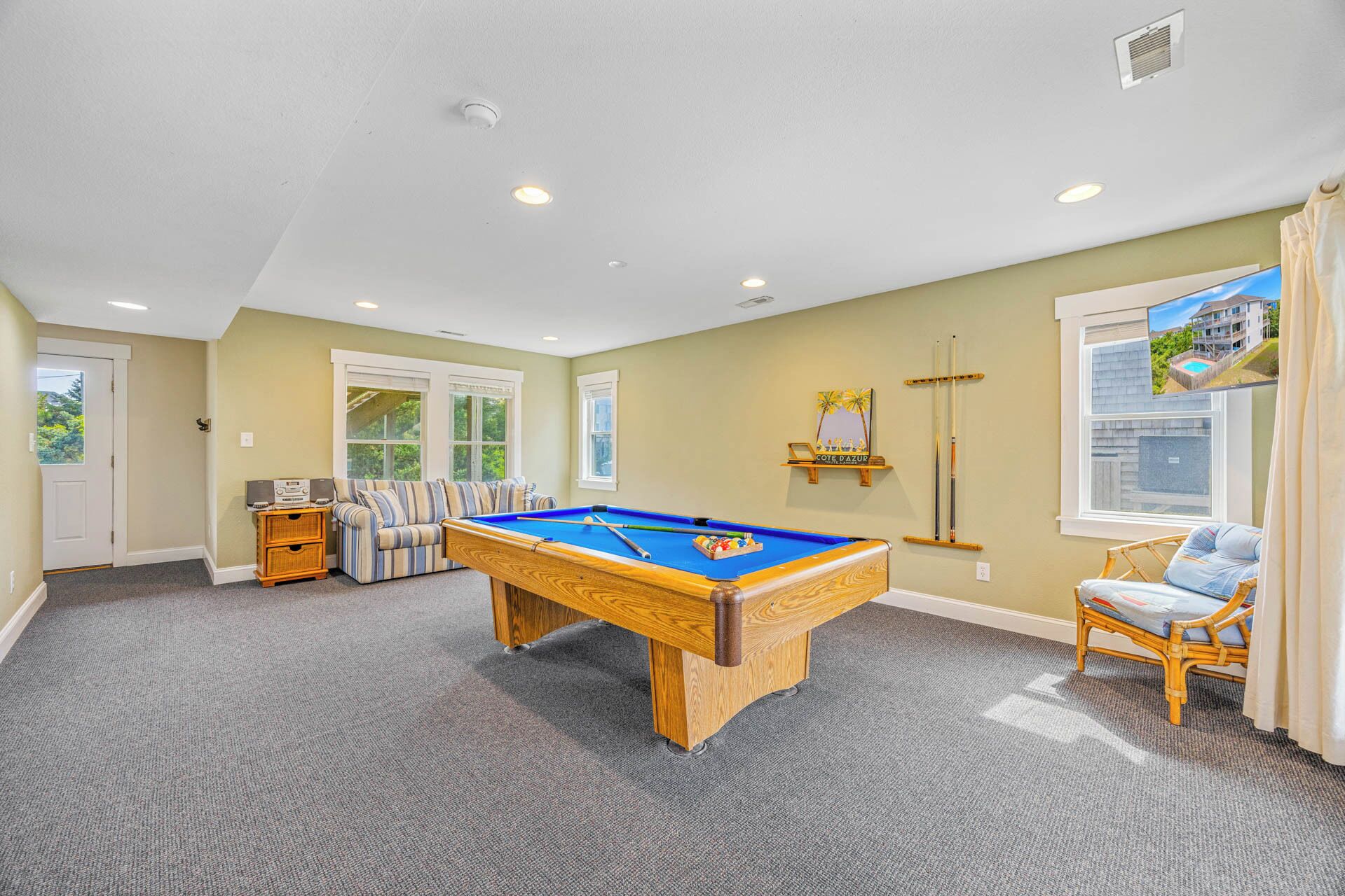 Challenge your travel companions to a friendly game on this beautiful billiard table in your spacious game room, complete with cozy seating and natural light.