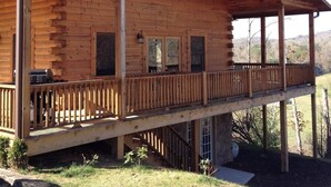 A log cabin with a covered porch and a steeply pitched roof. - Deep Creek Overlook Cabin HGTV Log Cabin Living WiFi Pool Table Hot Tub King Bed (Bryson City)