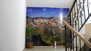 Una escalera con vistas a un paisaje urbano a través de un ventanal amplio.