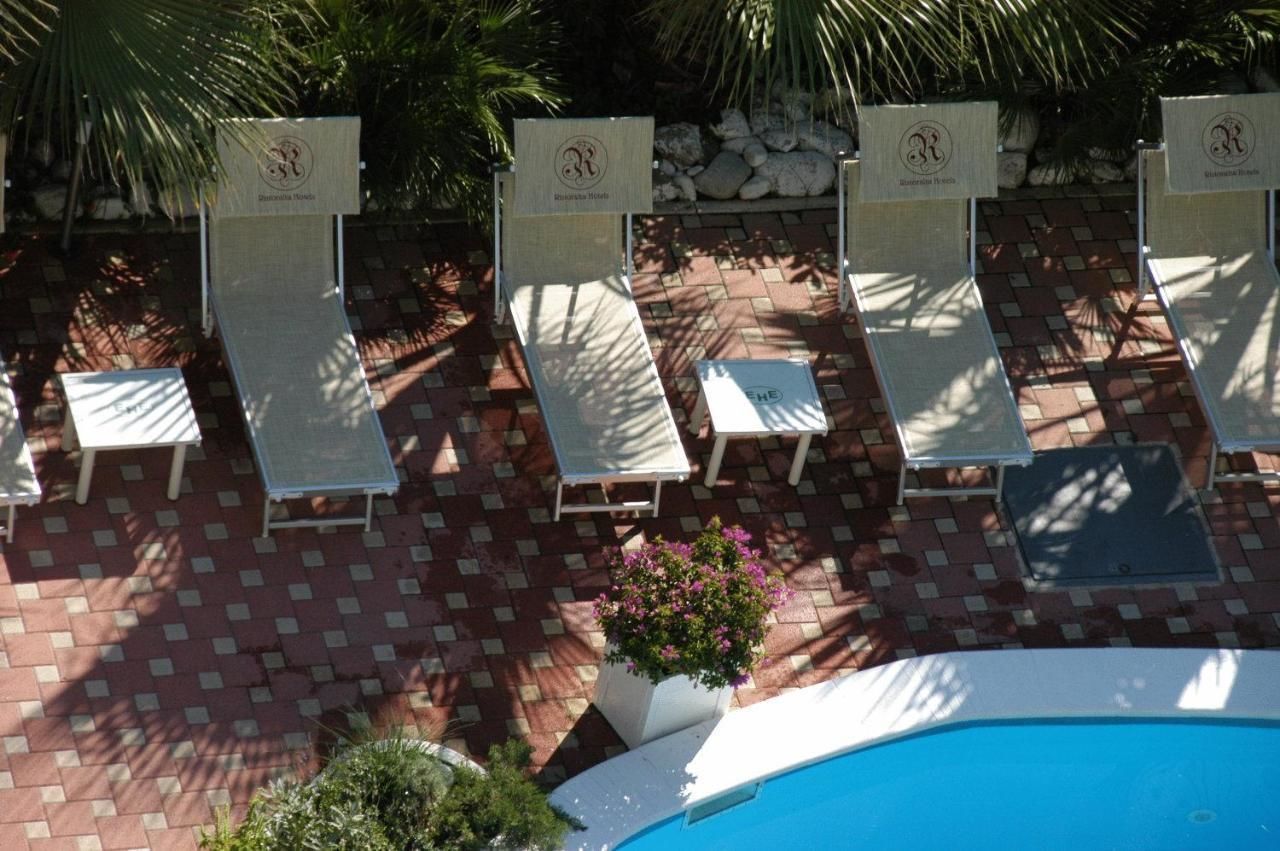 A poolside area with lounge chairs and a small pool.