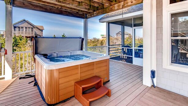 A wooden hot tub on a deck with a view of houses and trees. - Oceanview Home with Hot Tub, Game Room, Wet Bar, Grill. Feel That Summer Breeze! (Salvo)