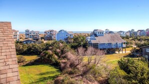 A coastal residential area with houses, some with ocean views. - Oceanview Home with Hot Tub, Game Room, Wet Bar, Grill. Feel That Summer Breeze! (Salvo)