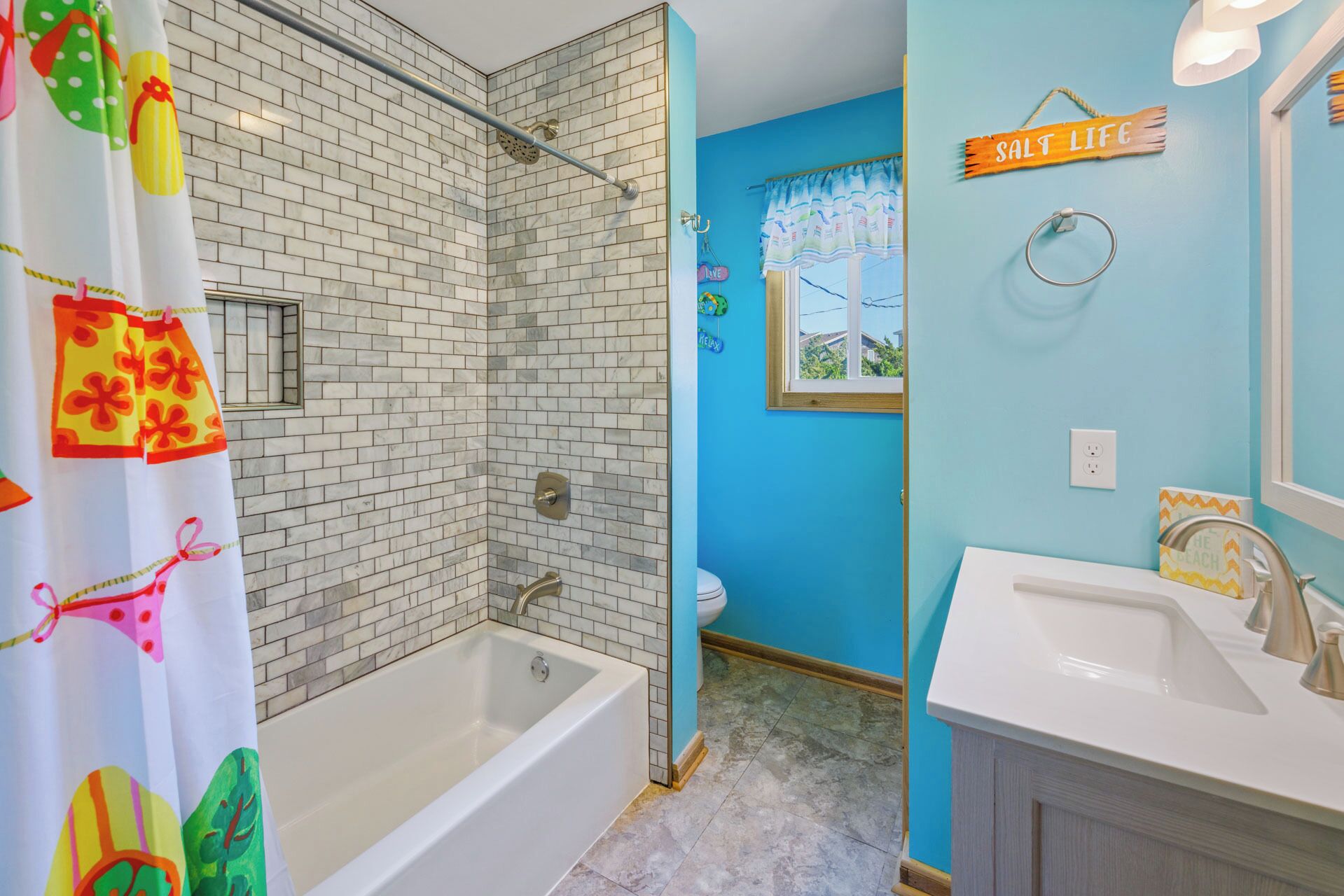 A bathroom with a shower, a bathtub, and a sink.