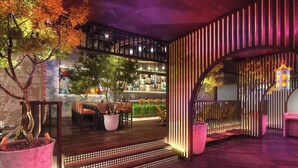 A modern interior with a bar area, seating, and a staircase with illuminated steps. - Aloft by Marriott Dubai Creek (Dubai)