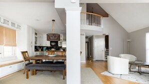 A spacious kitchen with a dining area, wooden flooring, and a staircase leading to an upper level. - Oasis in the City. Morningside/VaHi. Great in town location. (Atlanta)