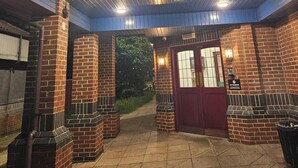 A hotel entrance with a prominent 'M' sign, brick pillars, and a covered walkway. - The Magnum Hotel, Sunderland City, Sure Collection by Best Western (Sunderland)