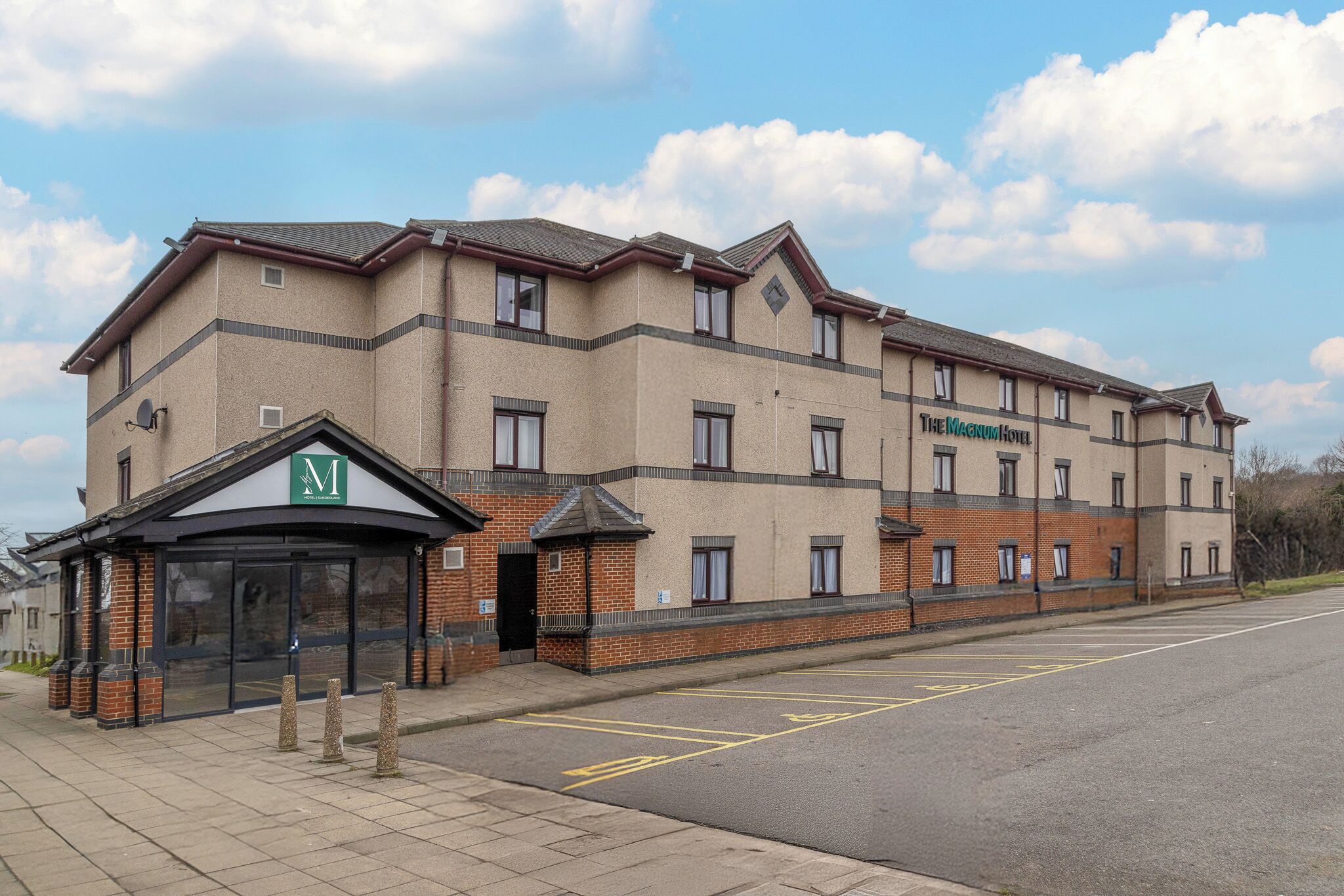 A multi-story hotel with a brick facade and a sign reading "The Mercure Hotel."