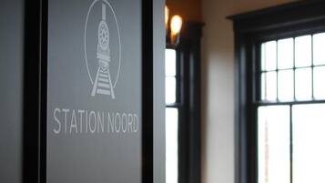 A framed sign with the text "STATION NOORD" and a graphic of a train.
