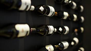 A wall of wine bottles arranged in rows.