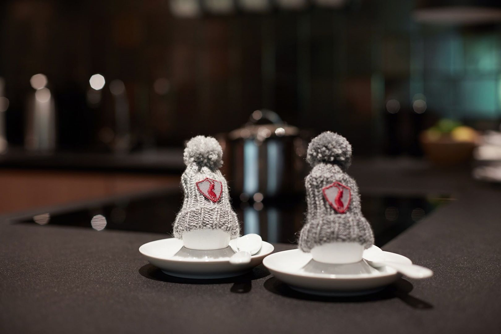Two knitted figures on plates, likely decorative items.