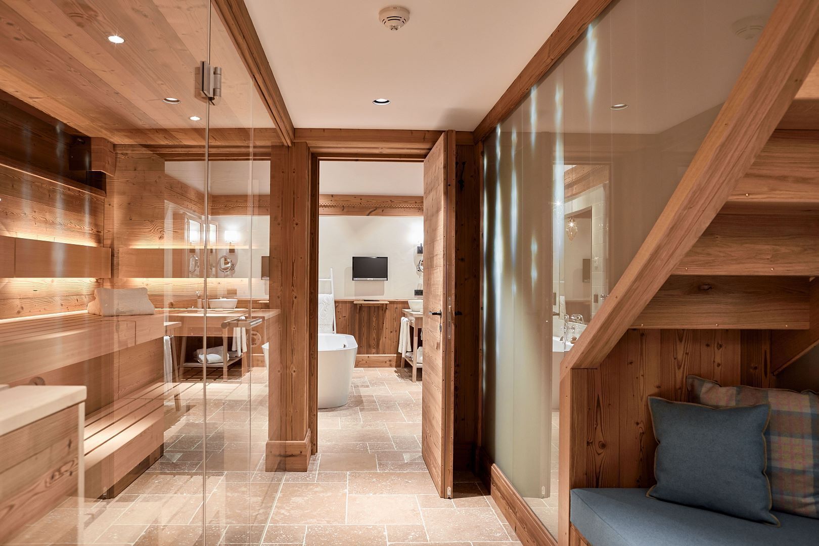 A modern bathroom with wooden accents, a bathtub, and a shower area.
