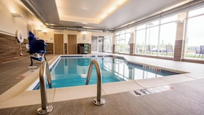 An indoor swimming pool with clear lanes, a lifeguard chair, and a view of the outside through large windows. - Fairfield Inn & Suites Philadelphia Broomall/Newtown Square (Broomall)