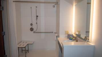 A modern bathroom with a walk-in shower, a toilet, and a sink.