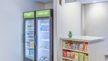 Two refrigerators labeled "cold" and "really cold," stocked with beverages and snacks.