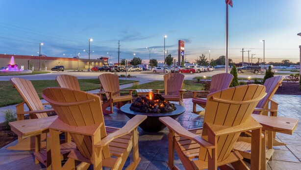 A patio area with Adirondack chairs and a central fire pit. - Hampton Inn & Suites Burlington (Burlington)