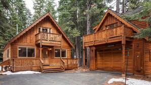 A cabin with a front porch, a garage, and a balcony. - Willow by Hauserman Rentals (Tahoe City)