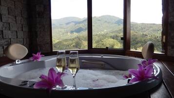 Unwind in a serene spa setting with a hot tub overlooking a breathtaking mountain view.