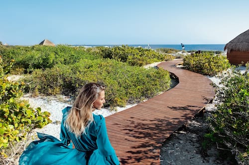 On the beach, white sand, beach cabanas, sun-loungers