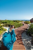On the beach, white sand, beach cabanas, sun loungers