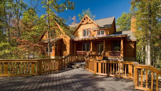 A wooden cabin with a deck, surrounded by trees. - The Preserve, Craftsman Special Vacation Home (Fall Creek Falls)