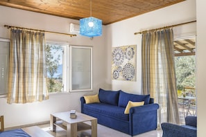 Relax in this inviting living space with a sofa, coffee table, and armchair.