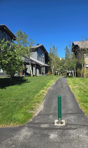 A pathway leading to a residential area with houses and trees. - Snowcreek Resort Vacation Rental 858 (Mammoth Lakes)