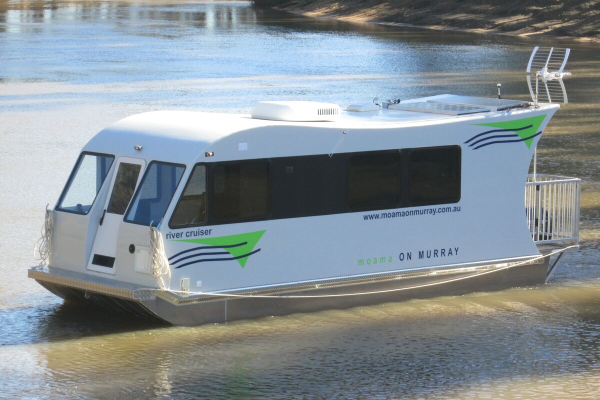 A river cruiser boat with a streamlined design, featuring a covered upper deck and a lower open deck.