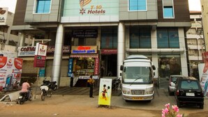 A hotel with a modern facade, a prominent sign for 'T-10 Hotels', and a visible entrance. - Plazza hotel , Trichy (Tiruchirappalli)