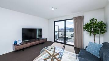 Deluxe Apartment | Living area | 50-inch flat-screen TV with cable channels, TV