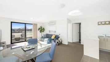 Deluxe Apartment | Living area | 50-inch flat-screen TV with cable channels, TV