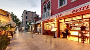 Ein Hotel mit einem Restaurant namens "Ristorante Bar Hotel", das einen Barbereich mit Flaschen und Gläsern bietet.