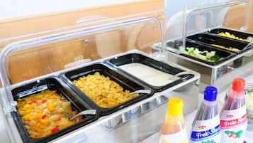 A buffet with various food options and condiments.