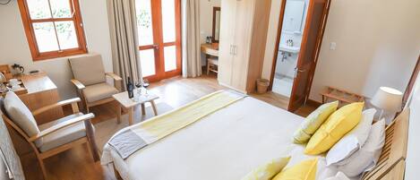 Hotellihuone, jossa on sänky, työpöytä, tuoli, televisio ja kylpyhuone.