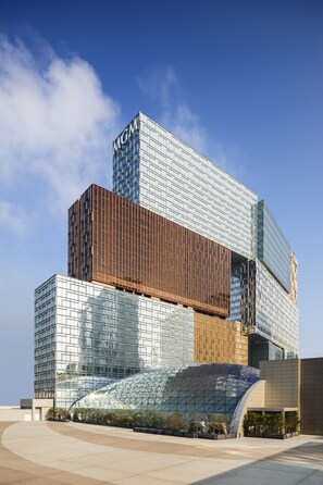 A modern building with a glass facade and a prominent MGM sign. - MGM COTAI (Cotai)