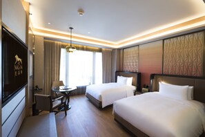 A hotel room with two beds, a desk, a chair, a TV, and a window with curtains. - MGM COTAI (Cotai)