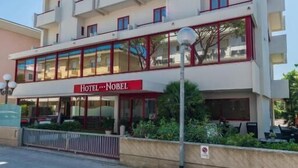 A multi-story hotel with balconies and a prominent 'Hotel Nobel' sign. - Hotel Nobel (Rimini)