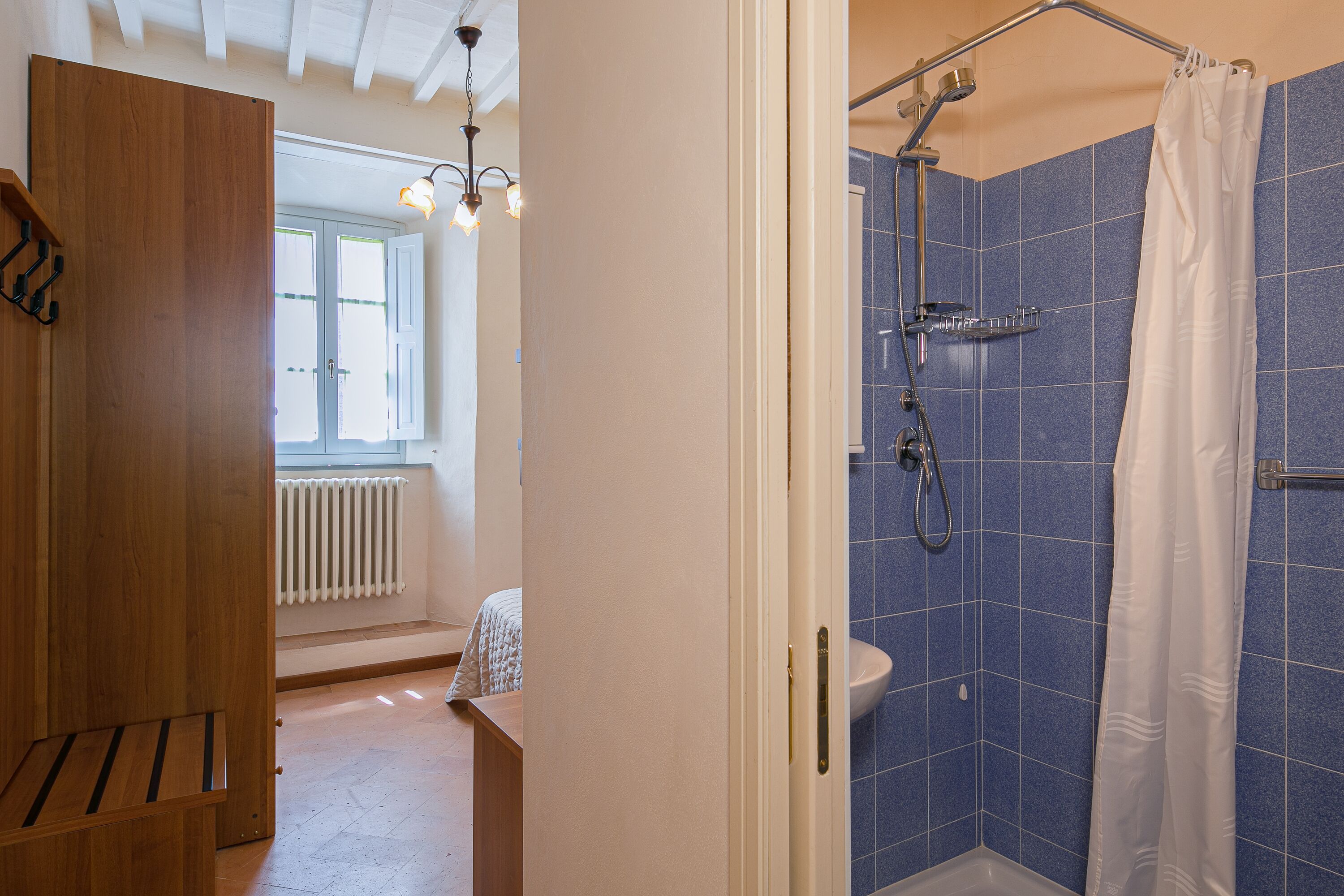 Un baño con ducha, inodoro y ventana.