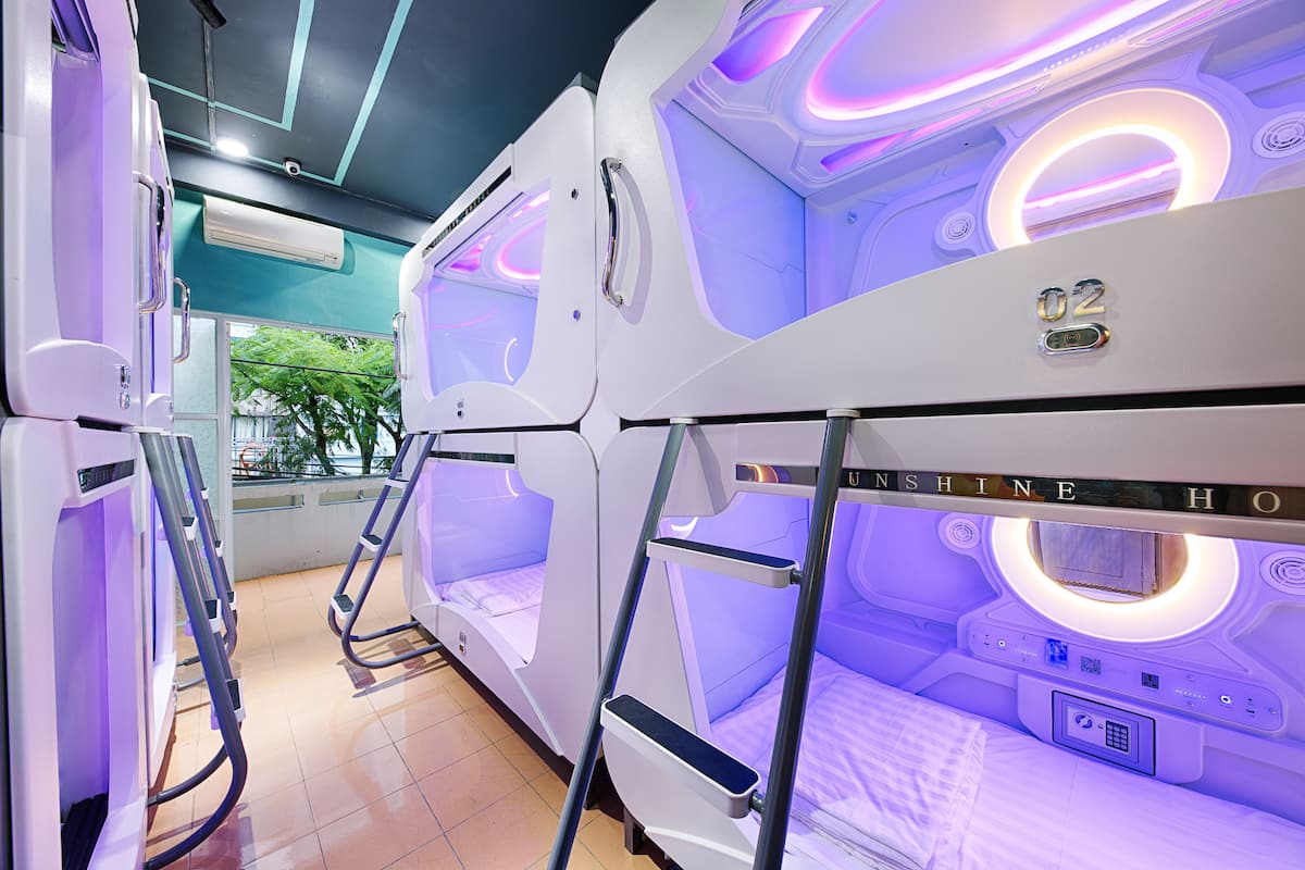A room with a bed, a control panel, and a window.