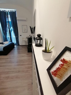 Ein modernes Wohnzimmer mit einer Couch, einem Couchtisch und einem Blumentopf.