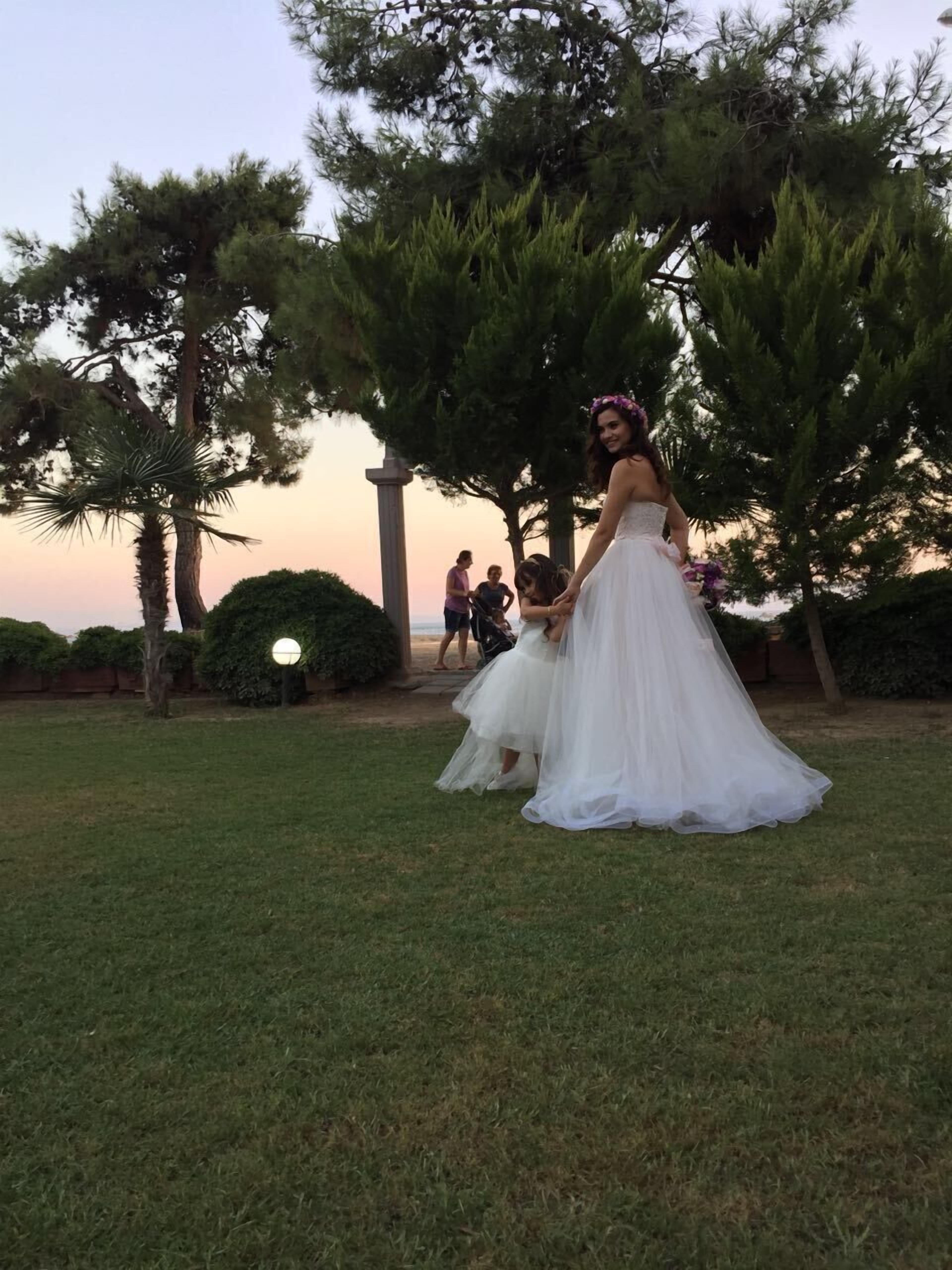 A wedding scene with a bride in a white dress and a groom in a dark suit.