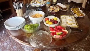 A buffet table with various food items and utensils. - La Dimora di Vesta (Lecce)